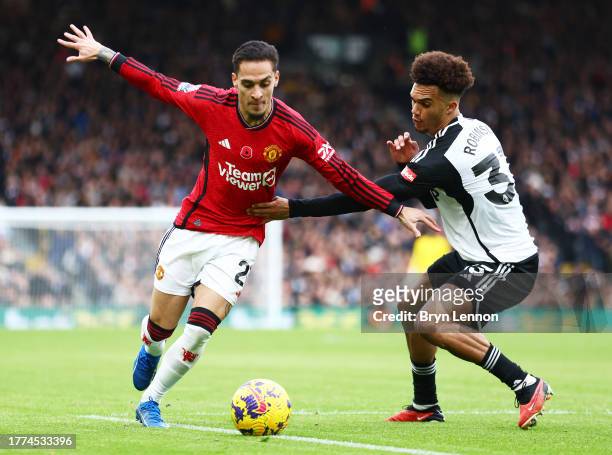 Antony of Manchester United is challenged by Antonee Robinson of Fulham during the Premier League match between Fulham FC and Manchester United at...