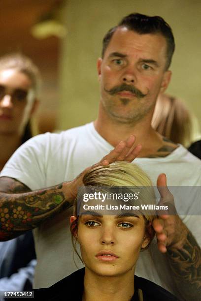 Model Luisa Hartema prepares backstage ahead of the MBFWA Trends show during Mercedes-Benz Fashion Festival Sydney 2013 at Sydney Town Hall on August...