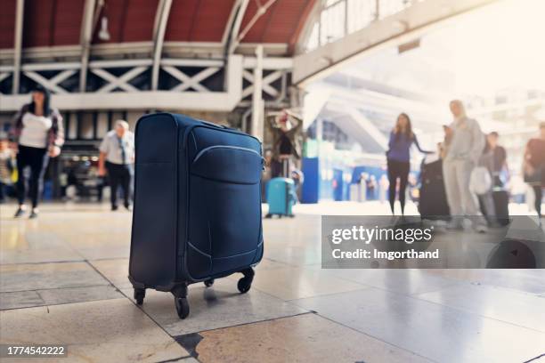 dangerous, unattended suitcase left alone at the crowded railroad station - packed suitcase stock pictures, royalty-free photos & images