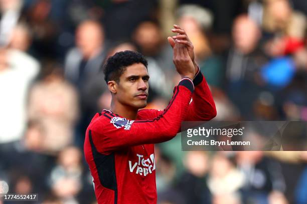 Raphael Varane of Manchester United applauds the fans following the team's victory during the Premier League match between Fulham FC and Manchester...