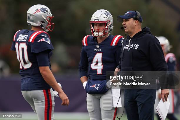 New England Patriots offensive coordinator Bill O'Brien speaks with Mac Jones and Bailey Zappe during the game against the Buffalo Bills at Gillette...