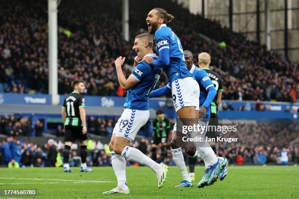 Vitaliy Mykolenko of Everton celebrates with teammate Dominic Calvert-Lewin after scoring the team's first goal during the Premier League match...