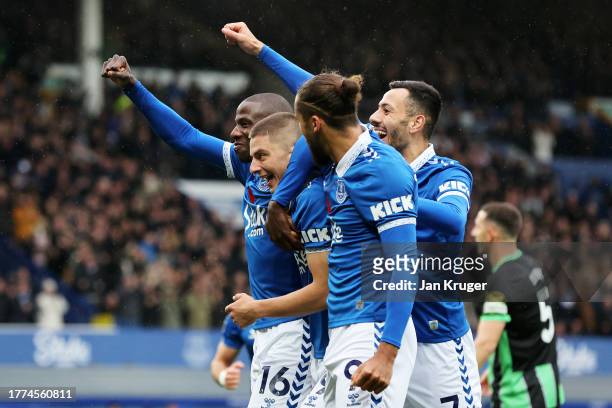 Vitaliy Mykolenko of Everton celebrates with teammates Abdoulaye Doucoure, Dwight McNeil and Dominic Calvert-Lewin after scoring the team's first...