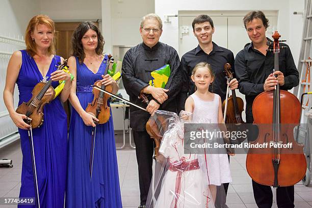 English 8-year-old violin prodigy, Alma Deutscher, foreground, violonist Shlomo Mintz and members of the New Russian Quartet, violonists Elena...