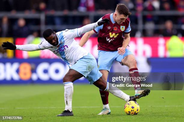 Jeffrey Schlupp of Crystal Palace challenges for the ball with Dara O'Shea of Burnley during the Premier League match between Burnley FC and Crystal...
