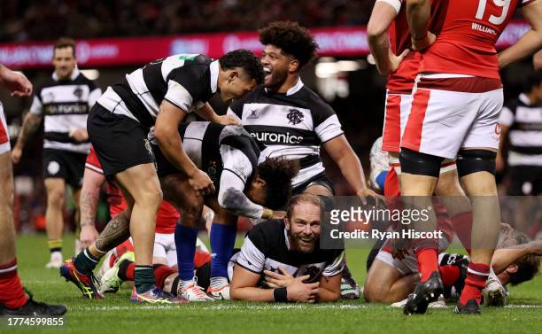 Alun Wyn Jones of Barbarians celebrates scoring his team's third try with teammates during the Test Match between Wales and Barbarians at...