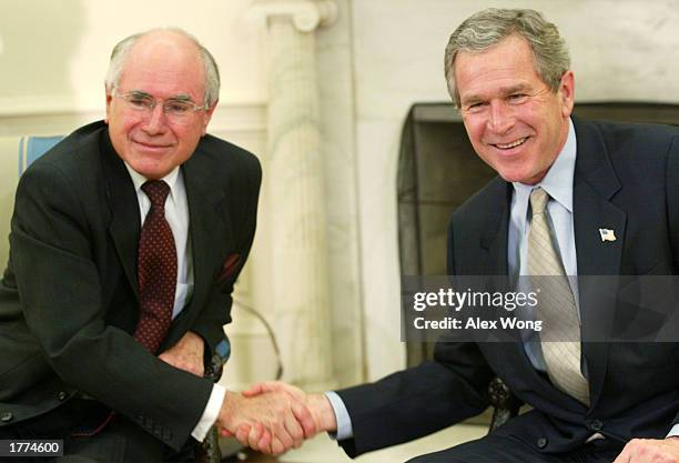 President George W. Bush shakes hands with Australian Prime Minister John Howard during their meeting February 10, 2003 at the Oval Office of the...