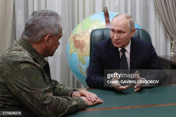 This pool photograph distributed by Russian state owned agency Sputnik late on November 9, 2023 shows Russia's President Vladimir Putin meetING with...