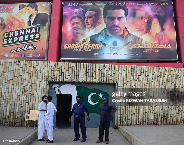 Pakistani customers arrive at a cinema to watch the newly released Pakistani film "Main Houn Afridi" in Karachi on August 23, 2013. A Pakistani film...