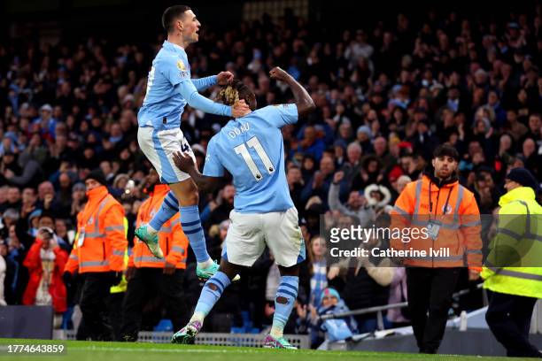 Phil Foden of Manchester City celebrates with Jeremy Doku of Manchester City after scoring the team's fourth goal during the Premier League match...