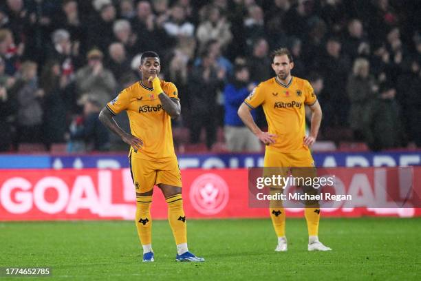 Mario Lemina and Craig Dawson of Wolverhampton Wanderers look dejected after Cameron Archer of Sheffield United scores the team's first goal during...