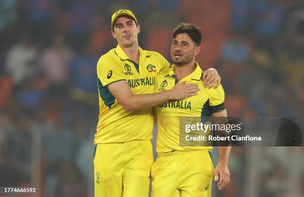 Marcus Stoinis and Pat Cummins of Australia celebrates the wicket of Chris Woakes of England during the ICC Men's Cricket World Cup India 2023...