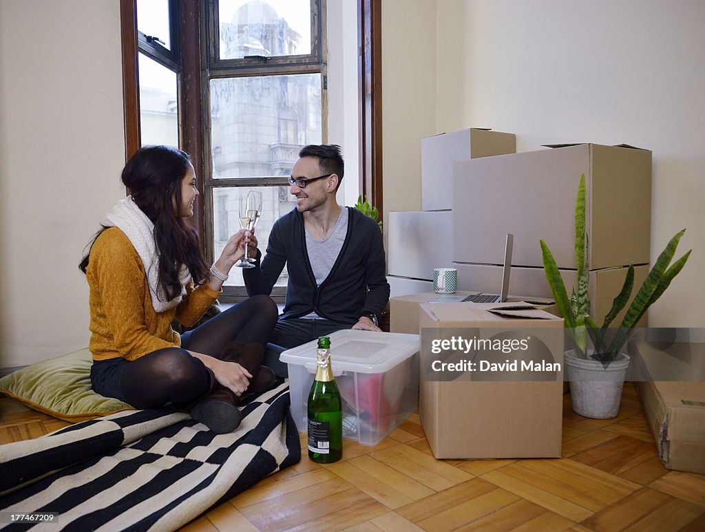 Young couple celebrating in their new apartment.