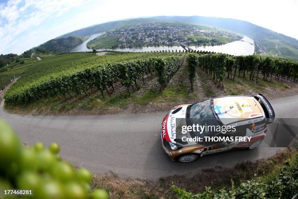 Finnish rallye pilot Mikko Hirvonen and his Italian co-pilot Jarmo Lehtinen drive through the vineyards during the fourth competition of the ADAC...