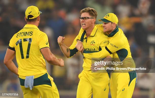 Adam Zampa of Australia celebrates with Steve Smith after dismissing Jos Buttler during the ICC Men's Cricket World Cup India 2023 between England...