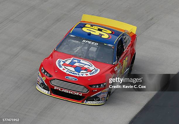 Scott Speed, driver of the Leavine Family Racing Ford, practices for the NASCAR Sprint Cup Series IRWIN Tools Night Race at Bristol Motor Speedway on...