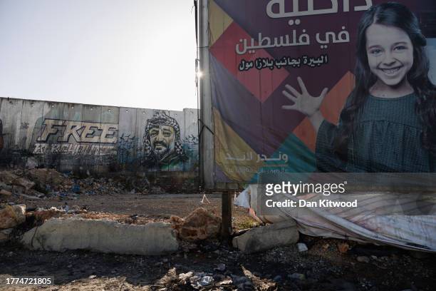 Mural on Israel's controversial separation wall between Jerusalem and Ramallah depicting the former chairman of the Palestine Liberation...