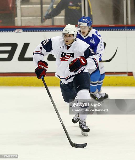 Thomas DiPauli of Team USA skates against Team Finland during the 2013 USA Hockey Junior Evaluation Camp at the Lake Placid Olympic Center on August...