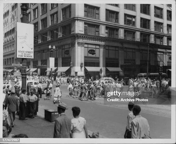 The busy cross-roads at Madison Street and State Street, Chicago, Illinois, circa 1930-1960.