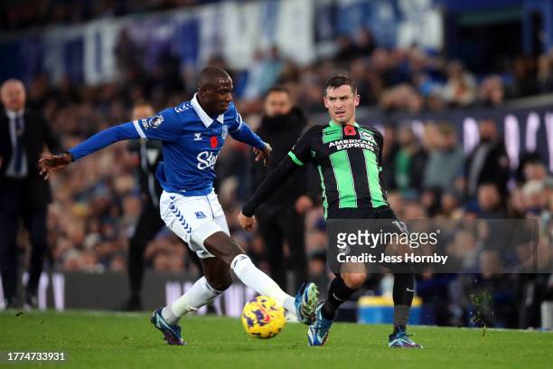 Pascal Gross of Brighton & Hove Albion passes the ball under pressure from Abdoulaye Doucoure of Everton during the Premier League match between...