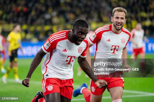 Dayot Upamecano of Munich celebrates with Harry Kane of Munich after scoring his team's first goal during the Bundesliga match between Borussia...