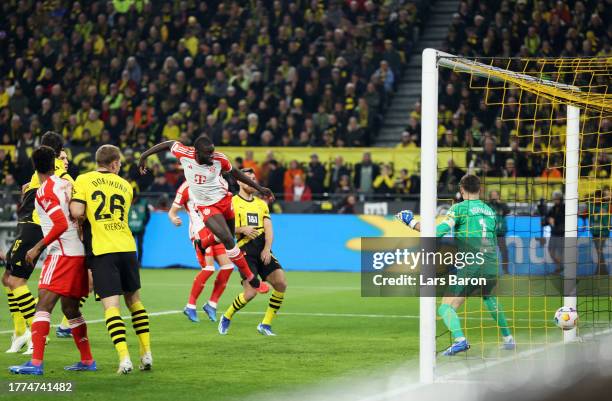 Dayot Upamecano of Bayern Munich scores the team's first goal during the Bundesliga match between Borussia Dortmund and FC Bayern München at Signal...