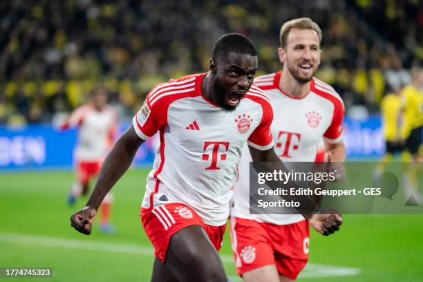 Dayot Upamecano of Munich celebrates with Harry Kane of Munich after scoring his team's first goal during the Bundesliga match between Borussia...