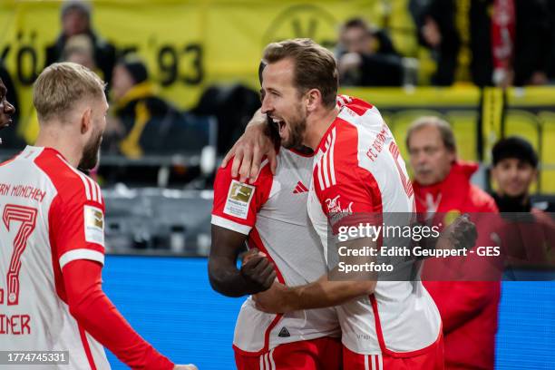 Dayot Upamecano of Munich celebrates with Harry Kane of Munich after scoring his team's first goal during the Bundesliga match between Borussia...