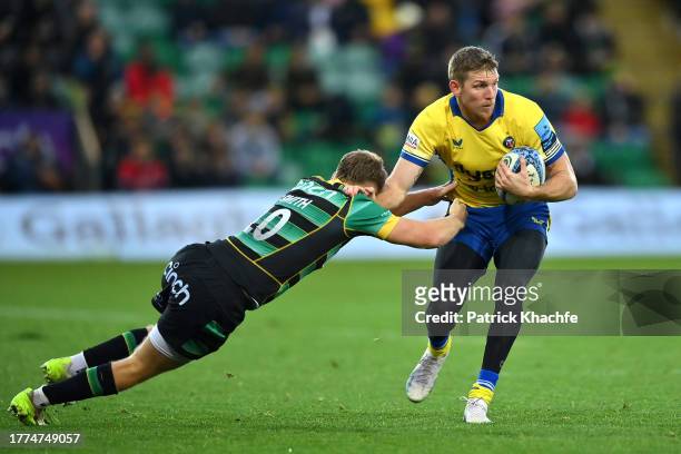 Ruaridh McConnochie of Bath Rugby is tackled by Fin Smith of Northampton Saints during the Gallagher Premiership Rugby match between Northampton...