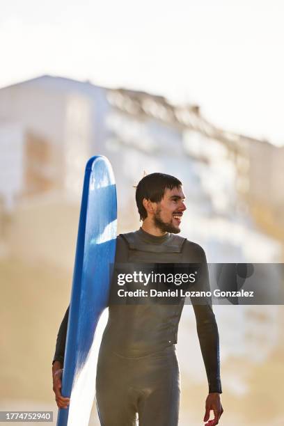 confident surfer with board in urban setting - in sport stock pictures, royalty-free photos & images