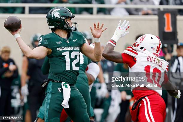 Katin Houser of the Michigan State Spartans throws a pass against Jimari Butler of the Nebraska Cornhuskers in the first quarter of a game at Spartan...