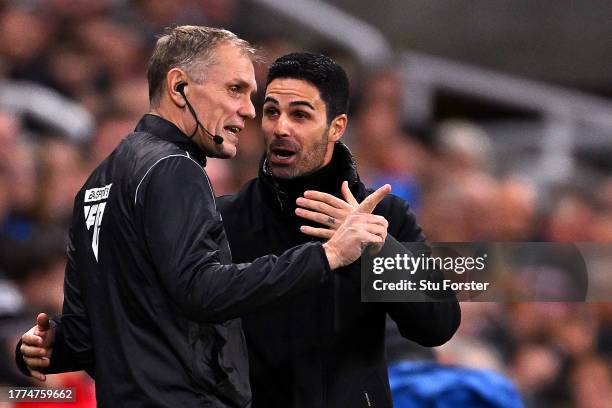 Mikel Arteta, Manager of Arsenal, talks to fourth official, Graham Scott during the Premier League match between Newcastle United and Arsenal FC at...