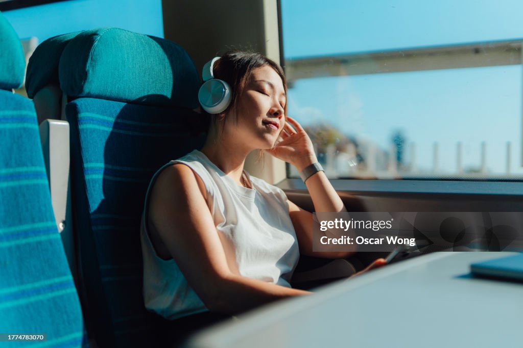 Young woman enjoying her journey in train