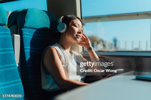 Young woman enjoying her journey in train Young woman enjoying her journey in train