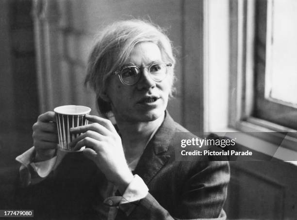 American pop artist Andy Warhol holding a paper cup, 9th August 1971.