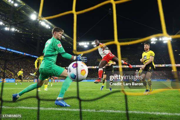 Dayot Upamecano of Bayern Munich scores the team's first goal past Gregor Kobel of Borussia Dortmund during the Bundesliga match between Borussia...