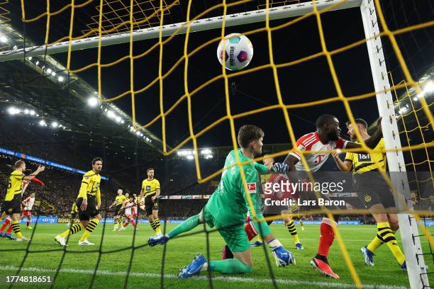 Dayot Upamecano of Bayern Munich scores the team's first goal past Gregor Kobel of Borussia Dortmund during the Bundesliga match between Borussia...