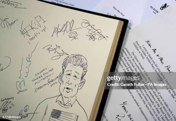 View of the signature and drawing of Brian Wilson featuring in an autograph book filled with signatures of over 40 performers from the 2002 Golden...