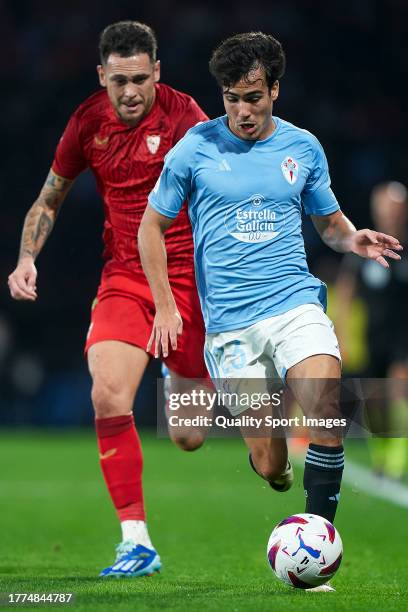 Manu Sanchez of RC Celta de Vigo is challenged by Lucas Ocampos of Sevilla FC during the LaLiga EA Sports match between RC Celta Vigo and Sevilla FC...