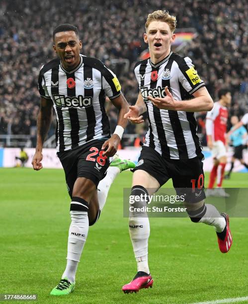 Anthony Gordon of Newcastle United celebrates with teammate Joe Willock after scoring the team's first goal during the Premier League match between...