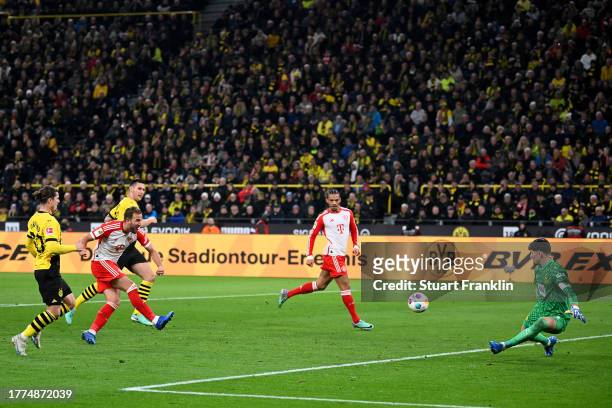 Harry Kane of Bayern Munich scores the team's third goal during the Bundesliga match between Borussia Dortmund and FC Bayern München at Signal Iduna...