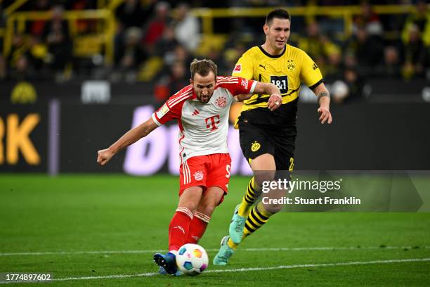 Harry Kane of Bayern Munich scores the team's fourth goal during the Bundesliga match between Borussia Dortmund and FC Bayern München at Signal Iduna...