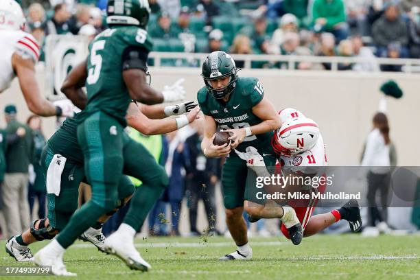 Katin Houser of the Michigan State Spartans is sacked by Cameron Lenhardt of the Nebraska Cornhuskers in the third quarter of a gameat Spartan...
