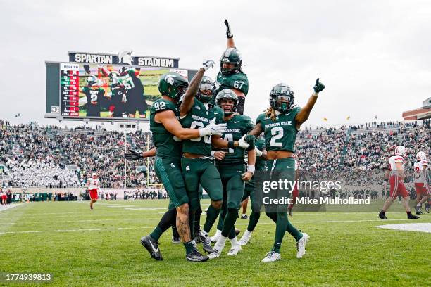 The Michigan State Spartans react after a touchdown by Montorie Foster Jr. #83 in the fourth quarter of a game against the Nebraska Cornhuskers at...