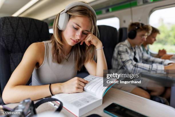 teenagers travelling by modern train - season 14 stockfoto's en -beelden