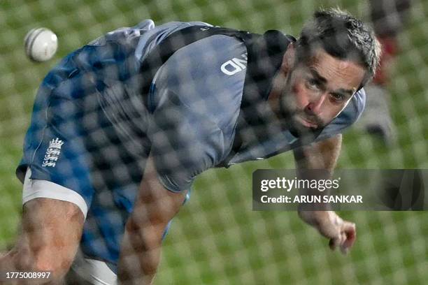 England's Chris Woakes bowls in the nets during a practice session on the eve of their 2023 ICC Men's Cricket World Cup one-day international match...