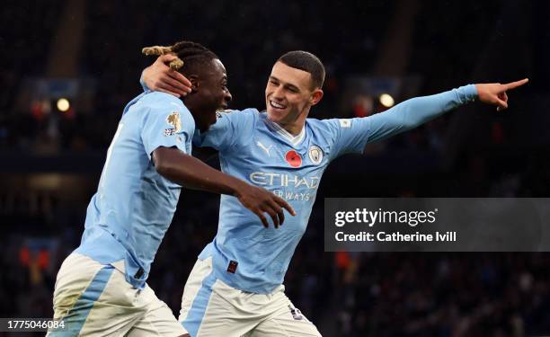 Phil Foden of Manchester City celebrates scoring the fourth goal with Jeremy Doku of Manchester City during the Premier League match between...