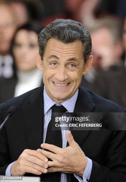 French President Nicolas Sarkozy gestures with his wedding ring as he delivers a speech during a meeting dedicated to independent workers on April...