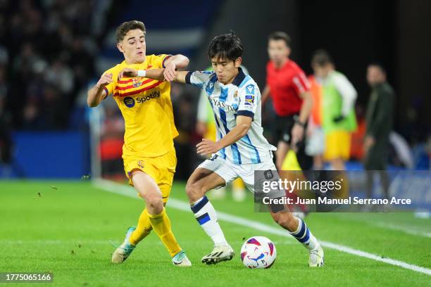 Takefusa Kubo of Real Sociedad is challenged by Gavi of FC Barcelona during the LaLiga EA Sports match between Real Sociedad and FC Barcelona at...