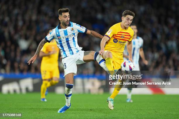 Brais Mendez of Real Sociedad battles for possession with Gavi of FC Barcelona during the LaLiga EA Sports match between Real Sociedad and FC...